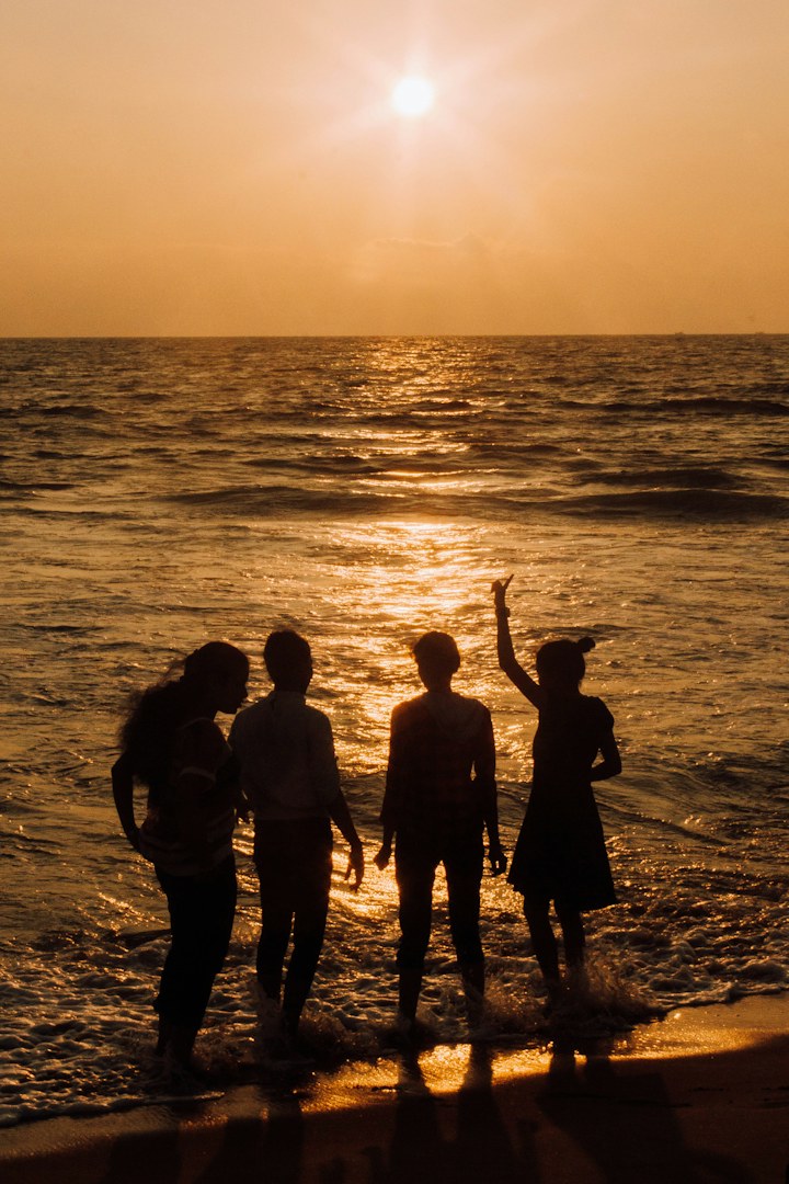 Friends together on a golden beach