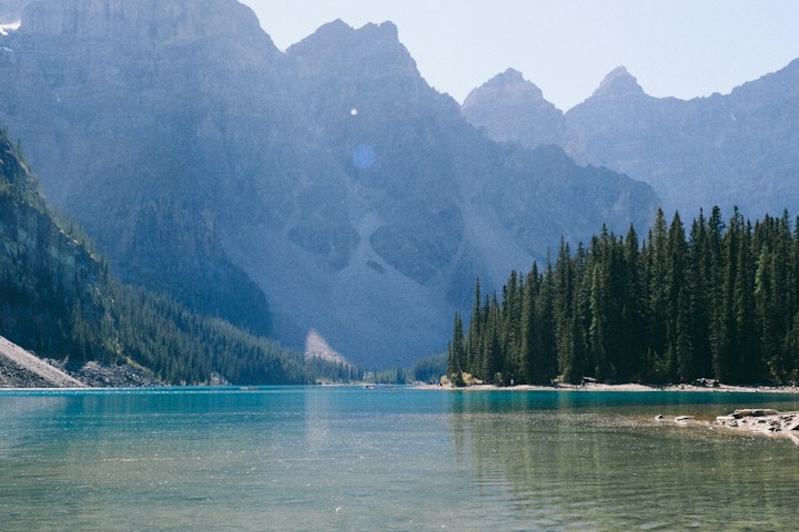 Turquoise lake below mountain peaks